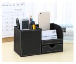Office desk accessory: leather PU pen holder and storage box with a coffee mug beside it.