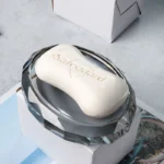 Bath set including bottle and cup on marble counter.