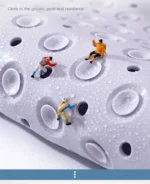 Non slip bath mat with suction cups in a white bathroom