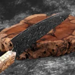 Damascus steel chef knife with woven wood handle on cutting board