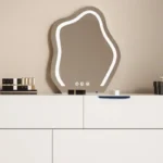White minimalist wood dresser with mirror and stool in modern bedroom setting