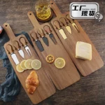 Acacia cheese board set with cheese knives and wooden cutting board on a table