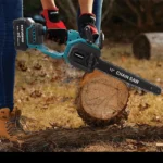 Cordless brushless chainsaw cutting a log in a garden