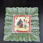 Christmas dinner plates with festive holly and berry pattern on a wooden table