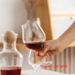 Kimura Shouko ultra thin wine glass on a wooden table, catching light