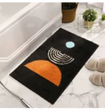 Modern abstract art non slip bathroom rug with vibrant colors and textured surface on a bathroom floor