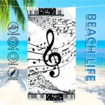 Vibrant guitar beach towel with colorful musical notes pattern on a sandy beach