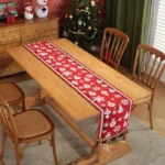 Red and green Christmas table runner with plaid pattern on dining table