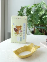 Cute fruit plate with Rilakkuma character in kawaii style on a ceramic plate with fruit slices