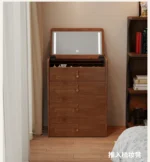 Wooden makeup vanity with mirror and stool in a modern bedroom setting