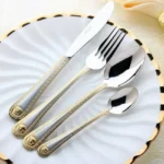 Gold plated flatware set 24-piece vintage western dinner fork knife spoon on table