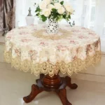 Elegant lace tablecloth with rose gold embroidery on a dining table