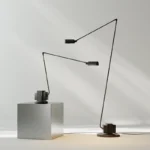 Italian design replica black floor lamp with tall stand and round shade, isolated on white background.