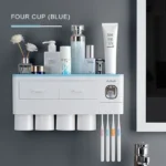 Cup included in the set, placed next to the dispenser, with a toothbrush inside.