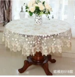 Elegant lace tablecloth with rose gold embroidery on a dining table
