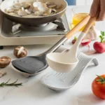 Silicone spoon rest holding a wooden spoon on a kitchen counter