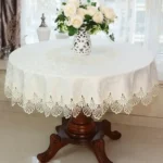 Elegant lace tablecloth with rose gold embroidery on a dining table