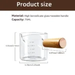 Clear espresso shot glass with handle on wooden surface