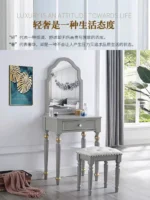 Modern white dressing table with mirror and stool in a bedroom setting