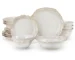 Elegant white stoneware dinner set with dinner plates, dessert plates, cereal bowls, and soup bowls on a wooden table