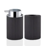 Foam soap dispenser and toothbrush holder set on a white marble countertop with a mirror reflection.