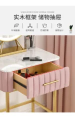 Marble top dressing table with lighted mirror and stool in a bedroom setting