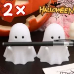 Ghost pen holder on a desk with Halloween decorations like pumpkins and cobwebs.