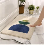 Modern abstract art non slip bathroom rug with vibrant colors and textured surface on a bathroom floor