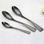 Luxury black 18/10 stainless steel cutlery set arranged on a table