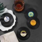Set of vinyl record coasters on a wooden table