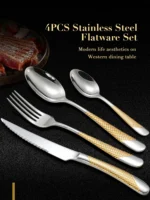 Elegant gold flatware set with steak knife, fork, and spoon on a dark table