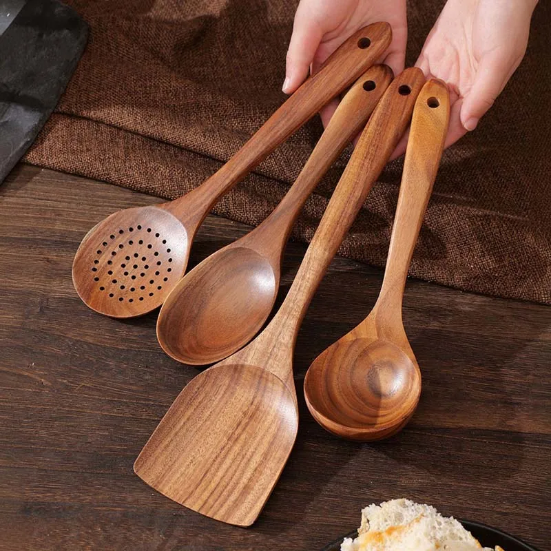 S0ddfb678054447b38b298ba81023496bE.webp Goldoma wooden cooking utensils set with teak wood spoons, spatula, and scraper on a kitchen counter