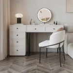 Modern minimalist makeup vanity table with mirror and stool in a bedroom setting
