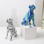 Close-up of the hand-painted boxer dog figurine with vibrant splashes.