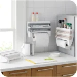 Goldoma wall mounted paper towel holder with storage rack and cutter in a modern kitchen