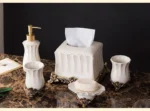 Rinsing cup with a matching lotion bottle, both featuring gold trim and floral motifs.