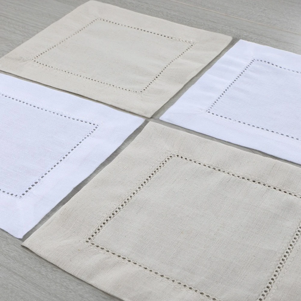 S0fb75a7971424be78537bbdf0288c21dB.webp White linen cloth napkins hemstitched cocktail napkins set of 100 on wooden table