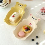 Cute fruit plate with Rilakkuma character in kawaii style on a ceramic plate with fruit slices