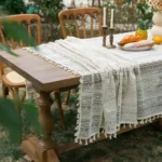 Retro polka dot tablecloth with fringe on a wooden table