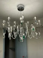 Modern stainless steel chandelier with crystal LED lights in a living room