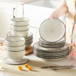 Vancasso handpainted dinnerware set in beige with spiral design on a wooden table