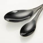 Luxury black 18/10 stainless steel cutlery set arranged on a table
