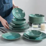 Vancasso KARST green stoneware dinner set with embossed plates and bowls on a rustic wooden table