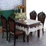 Elegant waterproof table protector with lace embroidery on a rectangular dining table