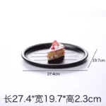 Black melamine dinner plates stacked elegantly on a wooden table