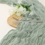 Rustic cheesecloth table runner on wooden table with boho decor