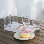 Transparent snow mountain whiskey glasses with Mount Fuji shape on a wooden table
