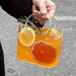 Korean ins style handbag shaped glass cup with straw on table