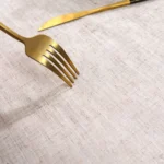 Round linen tablecloth with tassels on a dining table