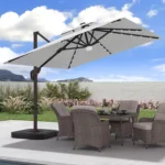 Goldoma large patio umbrella with lights illuminating a 9x9 FT square cantilever umbrella with solar LED lights in a bac